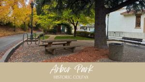 Arbor Park in Colfax, CA, featuring greenery, benches, and families enjoying the park.