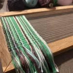 Handwoven textile on a handmade frame loom created during a beginner weaving workshop in Historic Downtown Colfax, California