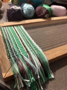 Handwoven textile on a handmade frame loom created during a beginner weaving workshop in Historic Downtown Colfax, California